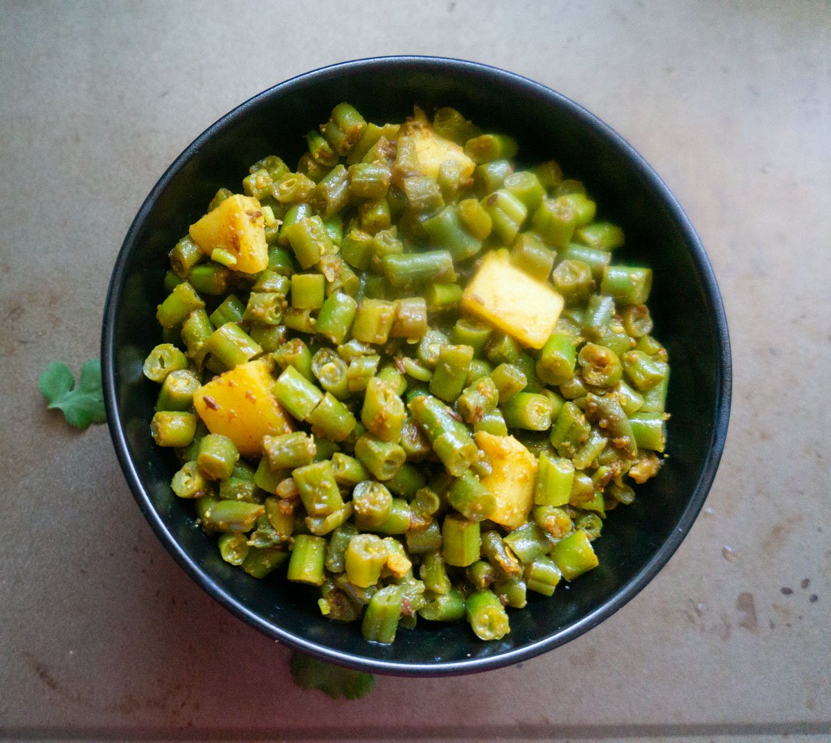Aloo beans ready to serve on a black bowl