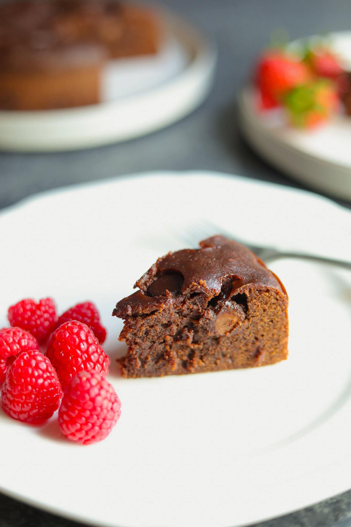 A piece of Instant Pot Brownie in a plate with raspberries