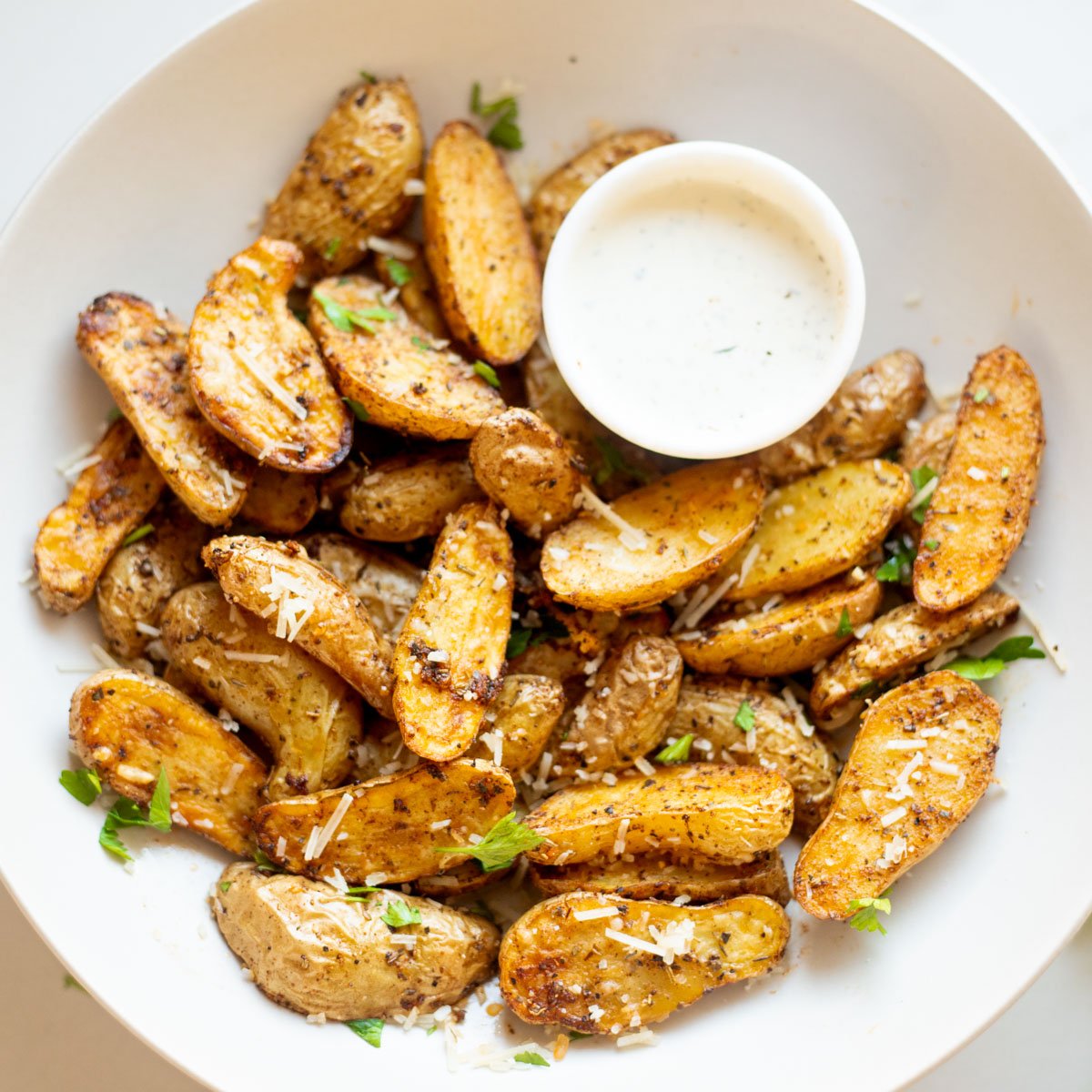 air fried fingerling potatoes in a plate with dip