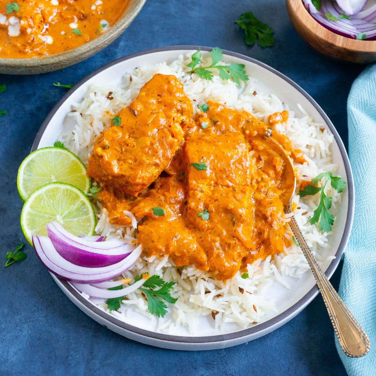 Salmon tikka masala curry made in instant pot served in a white plate with basmati rice.