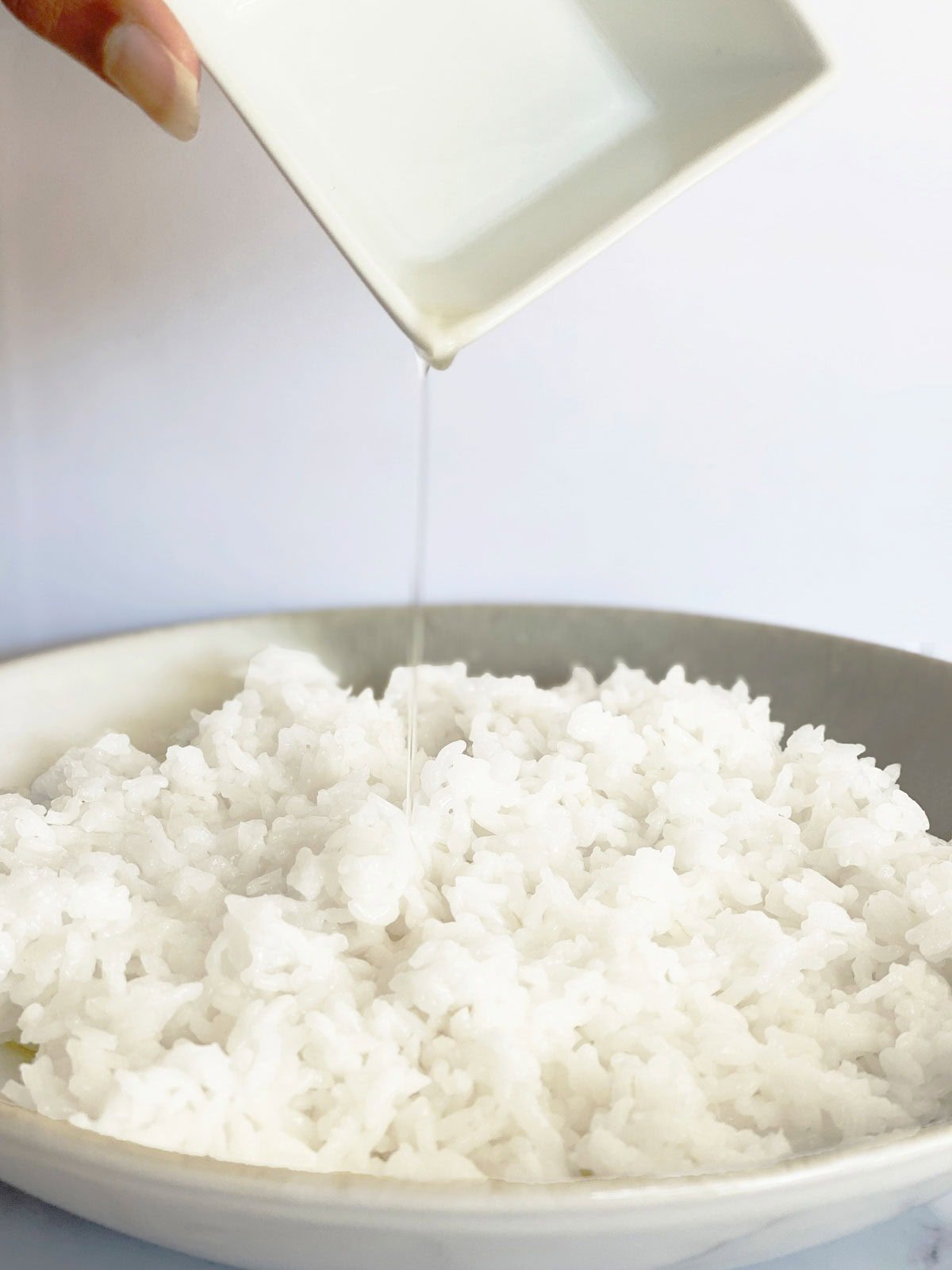 Add vinegar to cook rice to make sushi rice