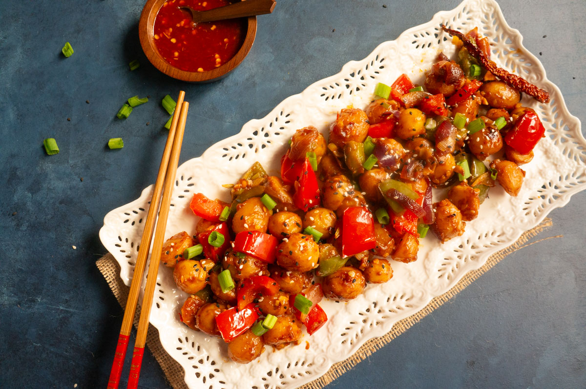 Flavorful and easy Garlic Chili Potatoes, made with steamed potatoes, garlic, chili sauce and honey, sprinkled with green onions and sesame seeds. Enjoy them as an appetizer or side! Garlic chili potatoes ready to serve topped with sesame seeds and green onion
