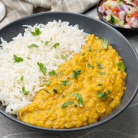 Ready to serve dal fry with rice in a black bowl