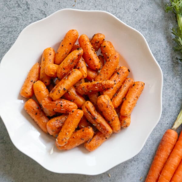 Garlic herb carrots on a white plate ready to serve