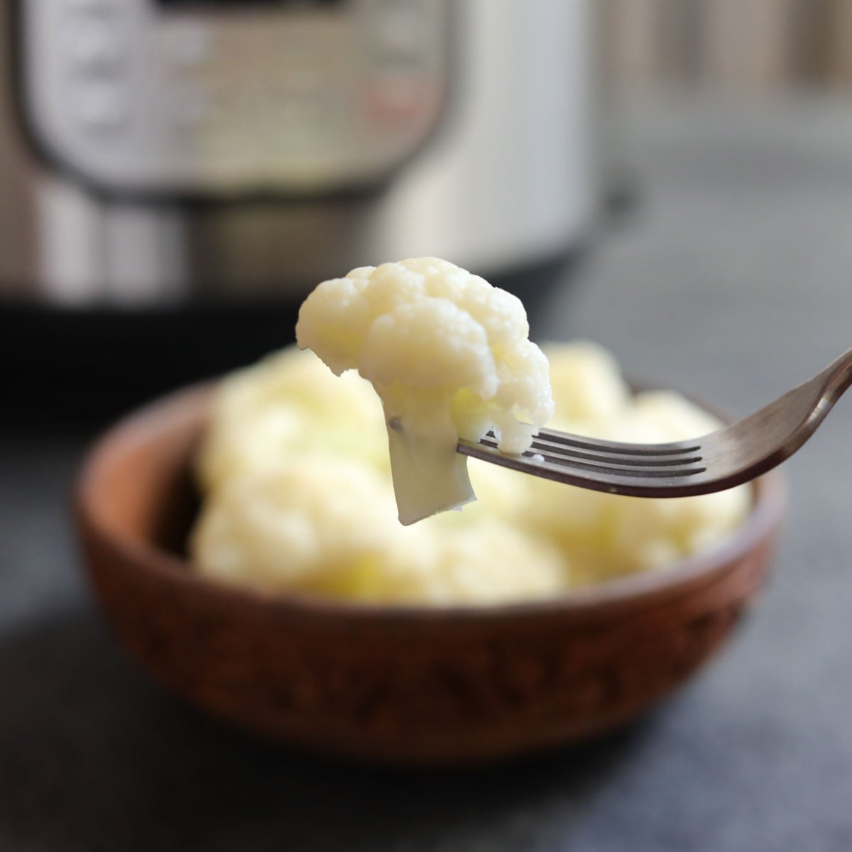 Steamed cauliflower cooked in instant pot on a fork
