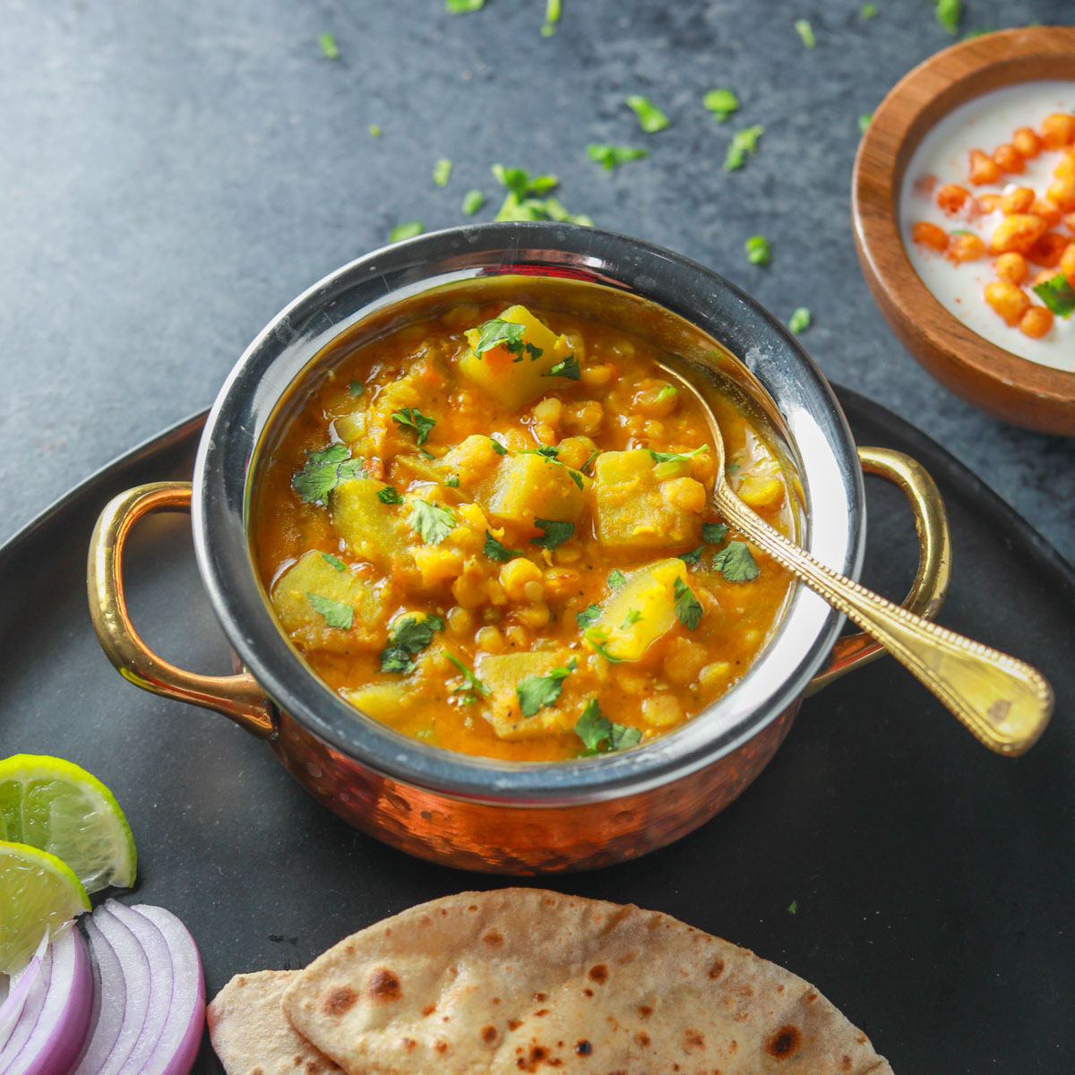 Lauki chana dal in a small pot with a spoon