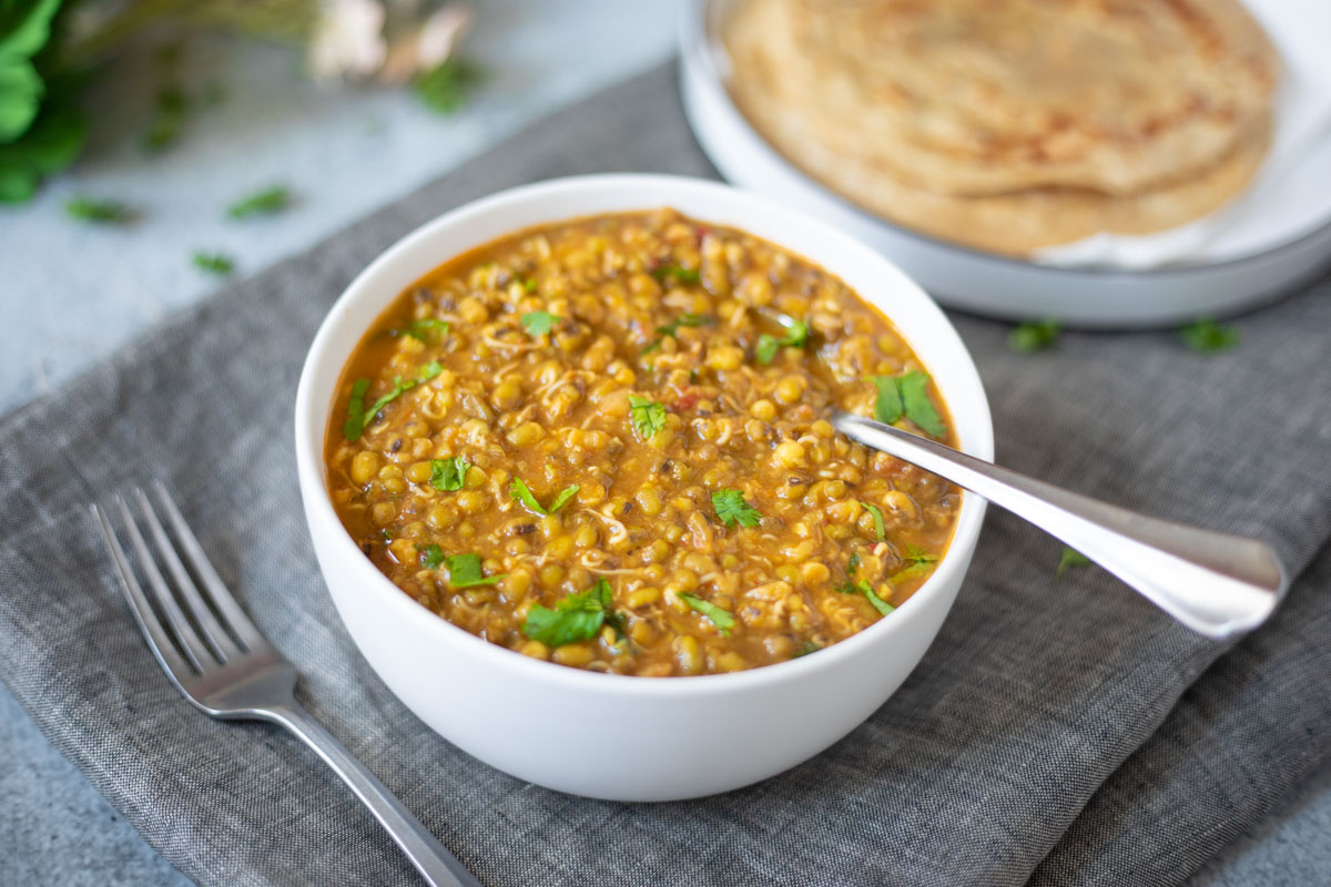 Ready to serve Moong Bean Sprouts Curry in a white bowl