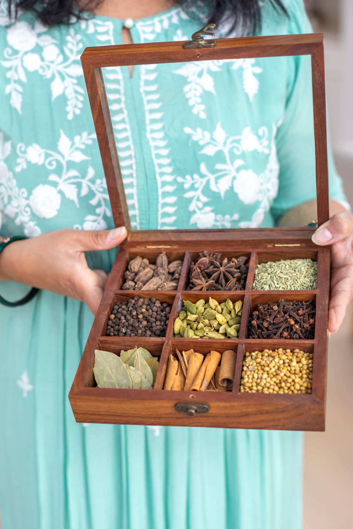 Indian spices in a wooden spice box with glass lid