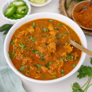 Chicken Chettinad in a white bowl garnished with cilantro