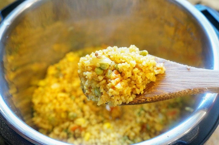 Dalia pulao on a wooden ladle