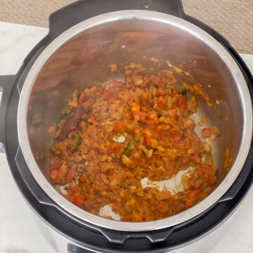 Saute tomato in instant pot to make dalia pulao