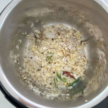 Saute onions with other ingredients to cook dalia pulao