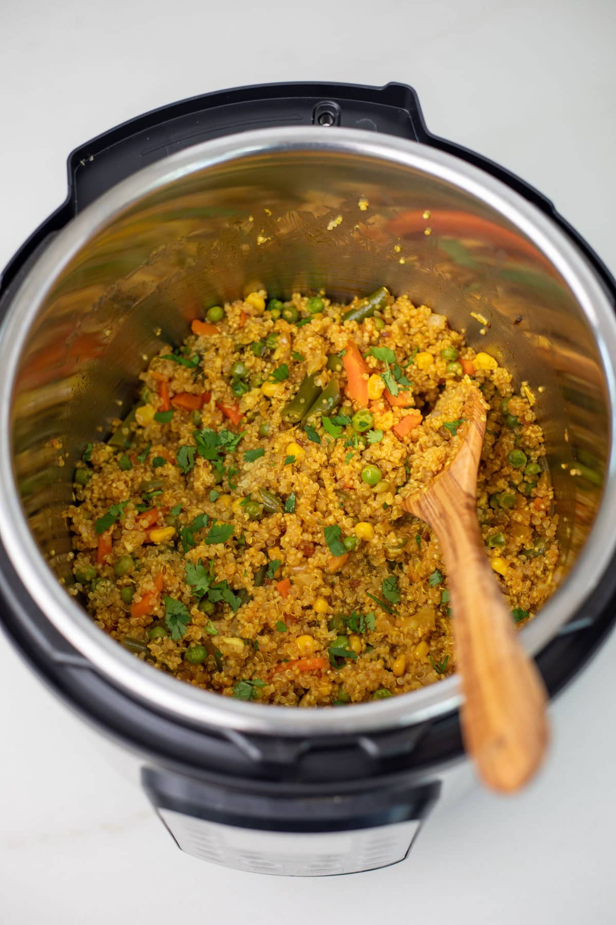 quinoa pulao in instant pot with wooden ladle