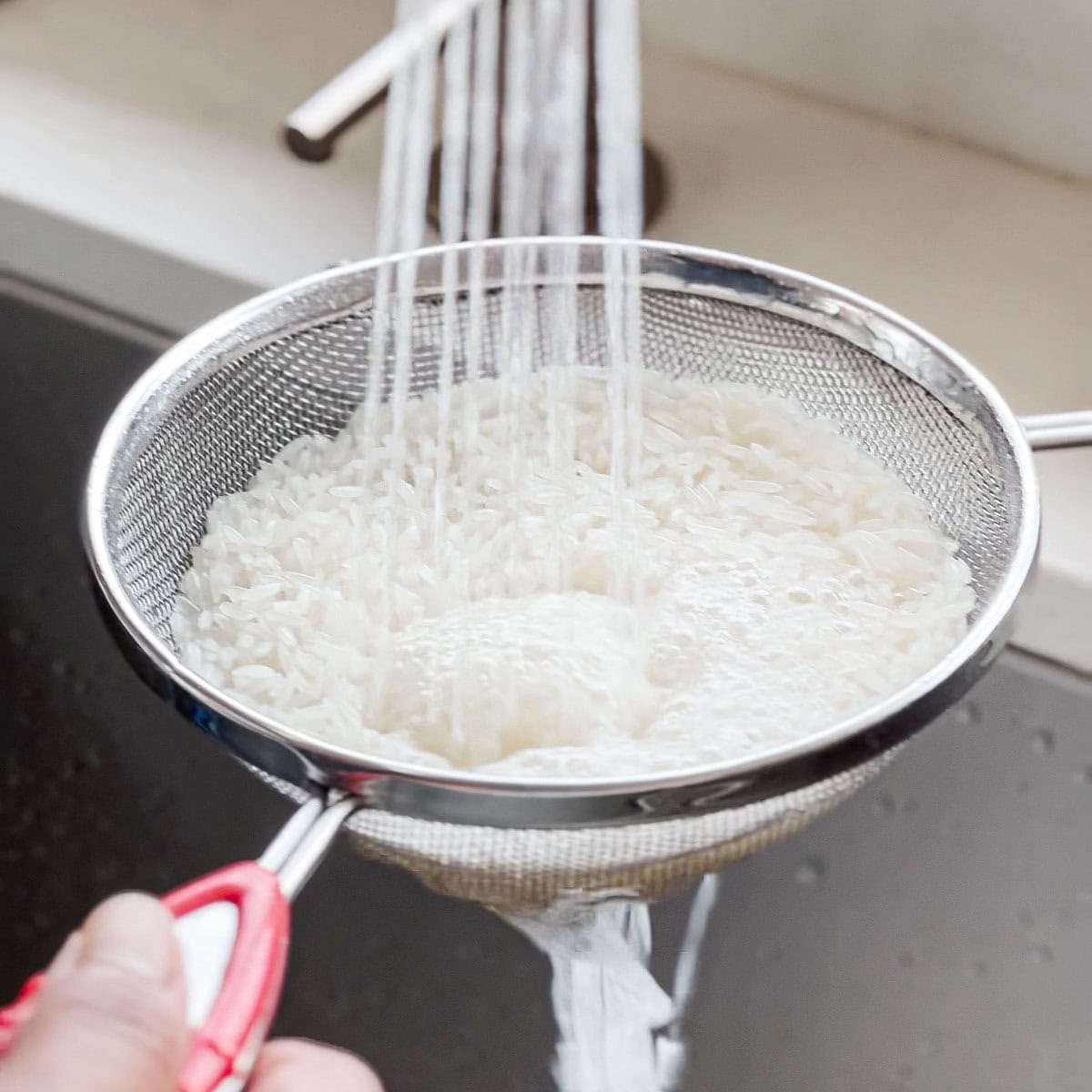 Wash jasmine rice using running water
