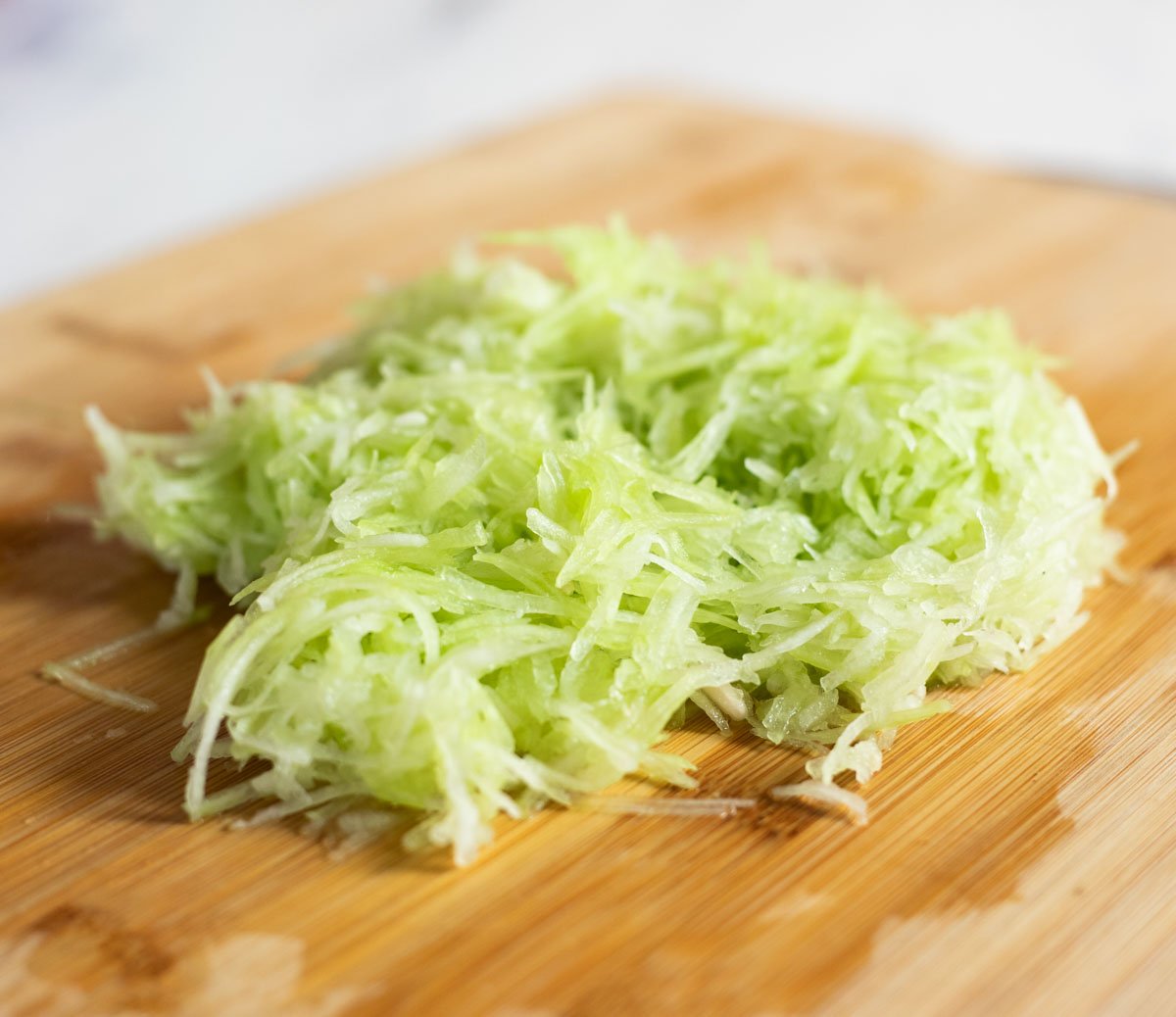 Grated lauki on a chopping board
