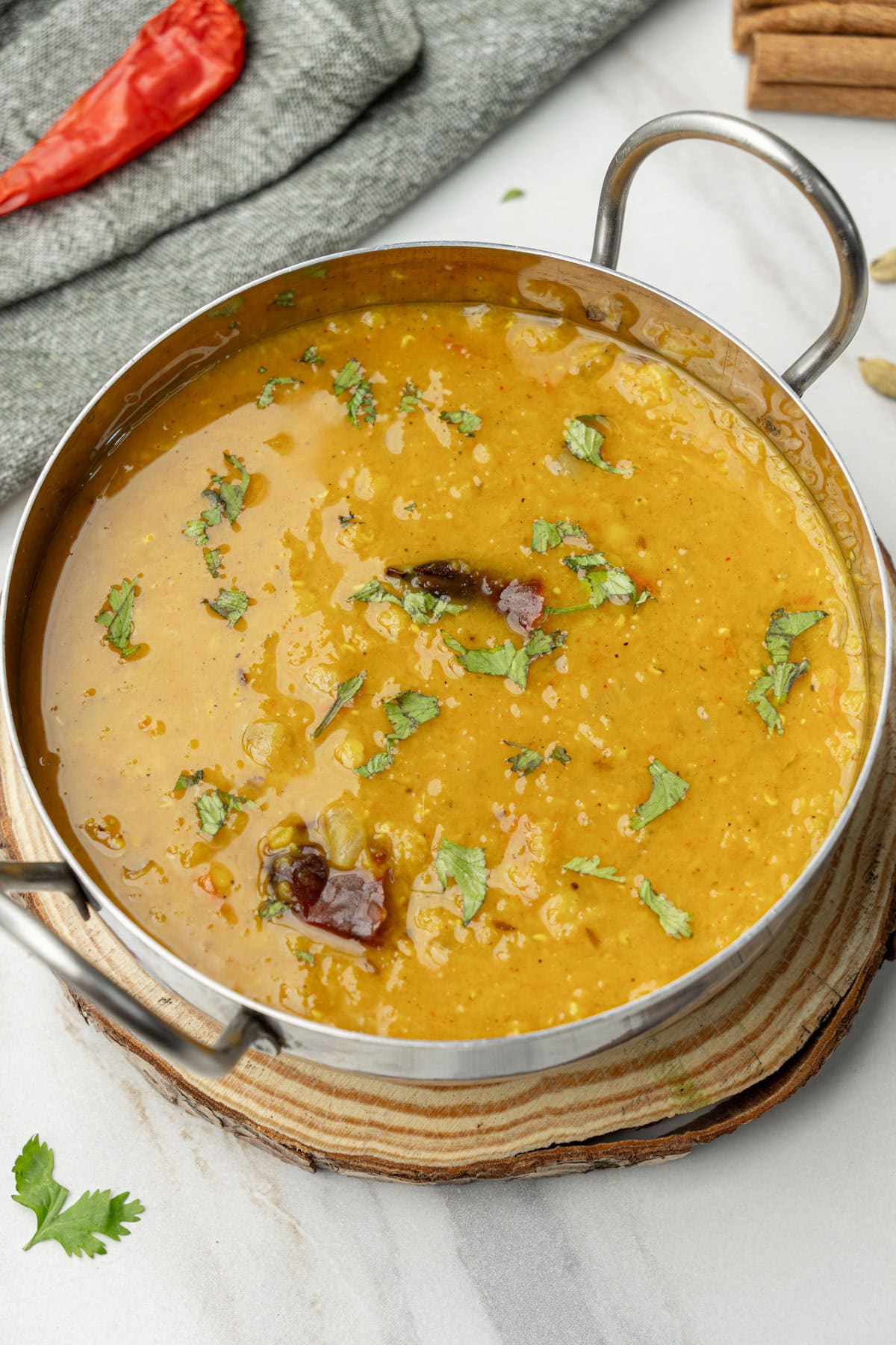 Masoor dal topped with cilantro in a stainless pot