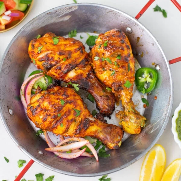 Air fryer tandoori chicken legs in a small pot