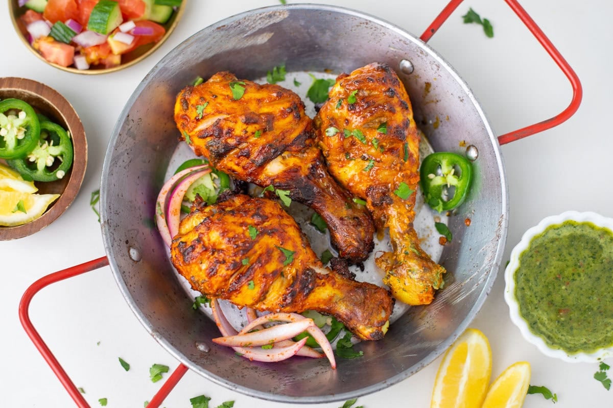top view of tandoori chicken legs in a small pot