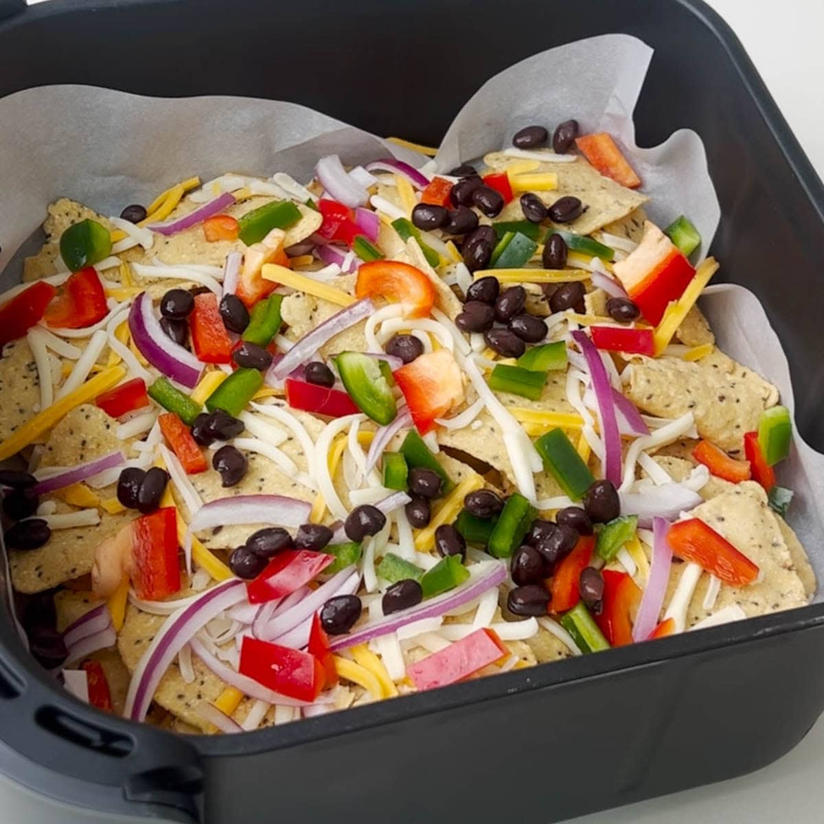 added black beans on top of nachos to make air fryer nachos
