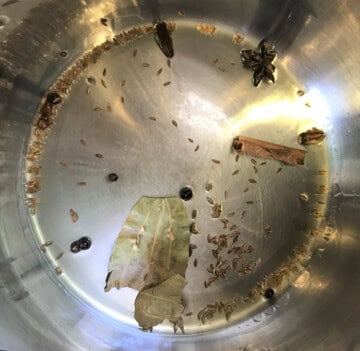 saute cumin seeds and whole spices in the instant pot to cook beet pulao