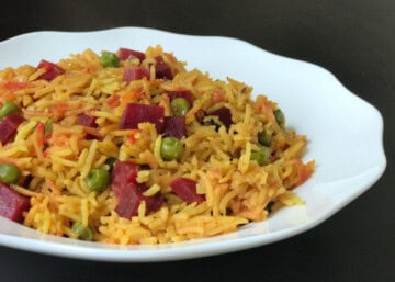 Closeup shot of beet pulao on a white plate