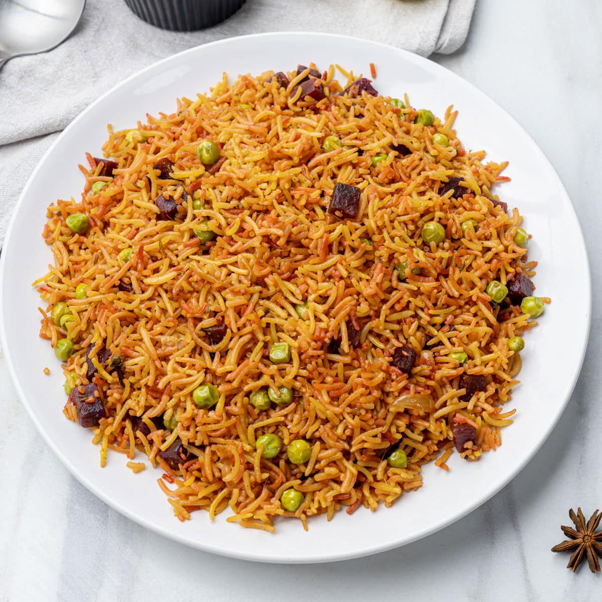 Ready to serve beet pulao on a white plate