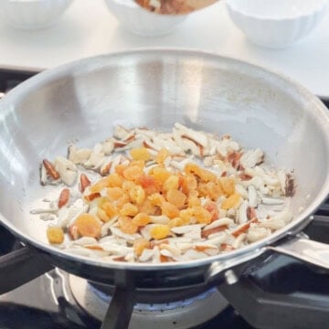 mixed nuts and raisins in the pan to make kheer recipe