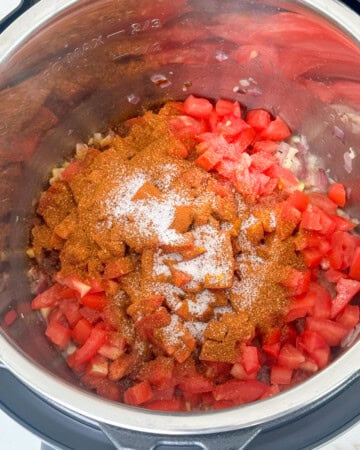 Saute onions and tomatoes to make pav bhaji in instant pot