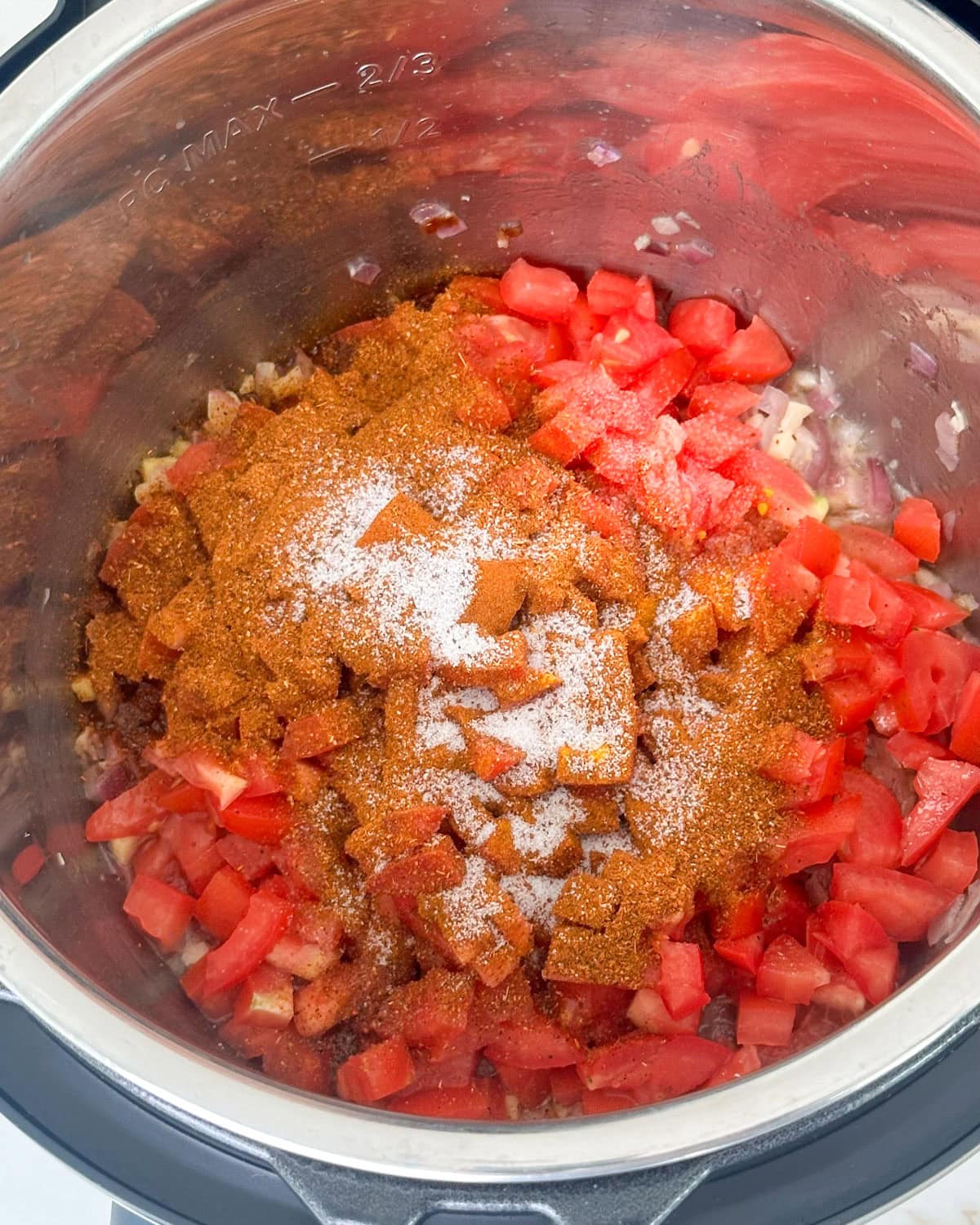 Saute onions and tomatoes to make pav bhaji in instant pot