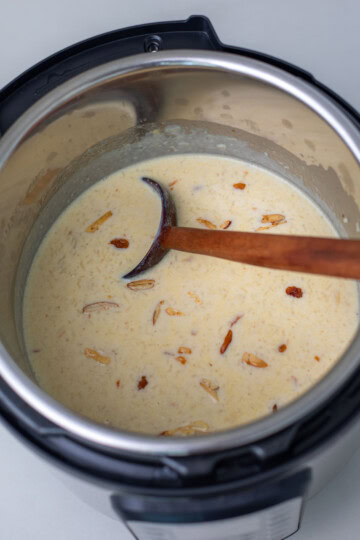 rice kheer in instant pot with a wooden ladle
