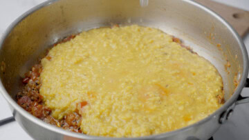 Add cooked dal into the pot to make masoor dal
