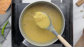Cooked masoor dal on a ladle