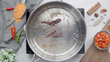 Saute cumin seeds and dried red chili to cook masoor dal