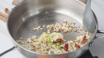 saute ginger, garlic, and green chili to make masoor dal