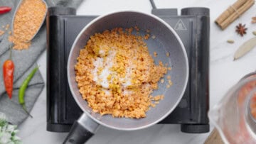 cook masoor dal with turmeric and salt in the pot