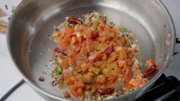 tomato and spices into the pot to cook masoor dal