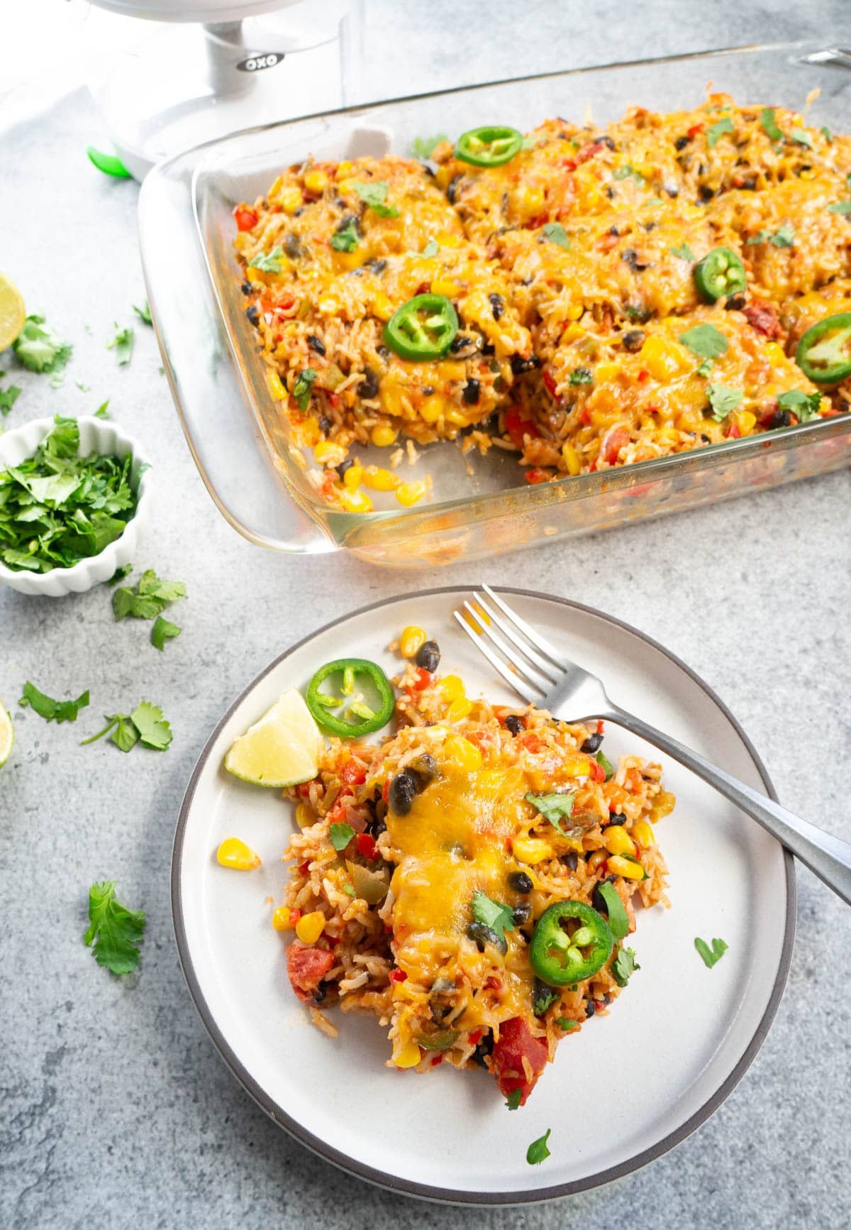 Vegetarian Mexican Casserole with Rice & Beans served on a white plate along with a fork.