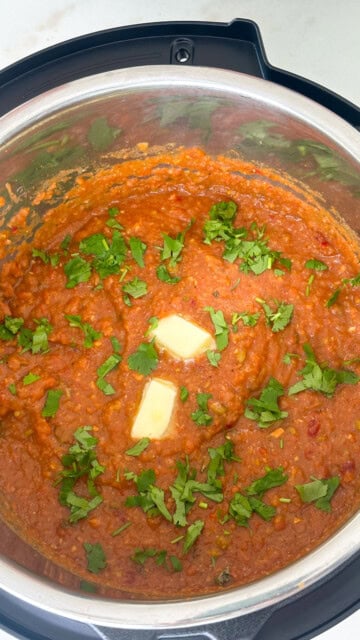 Pav bhaji in instant pot topped with butter and cilantro