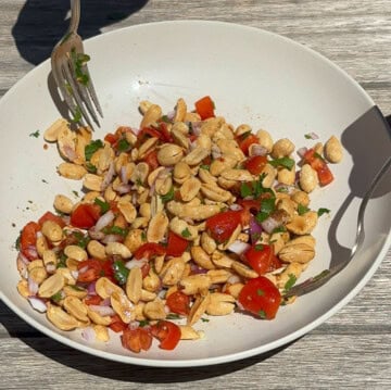 mixing peanut chaat in a white bowl