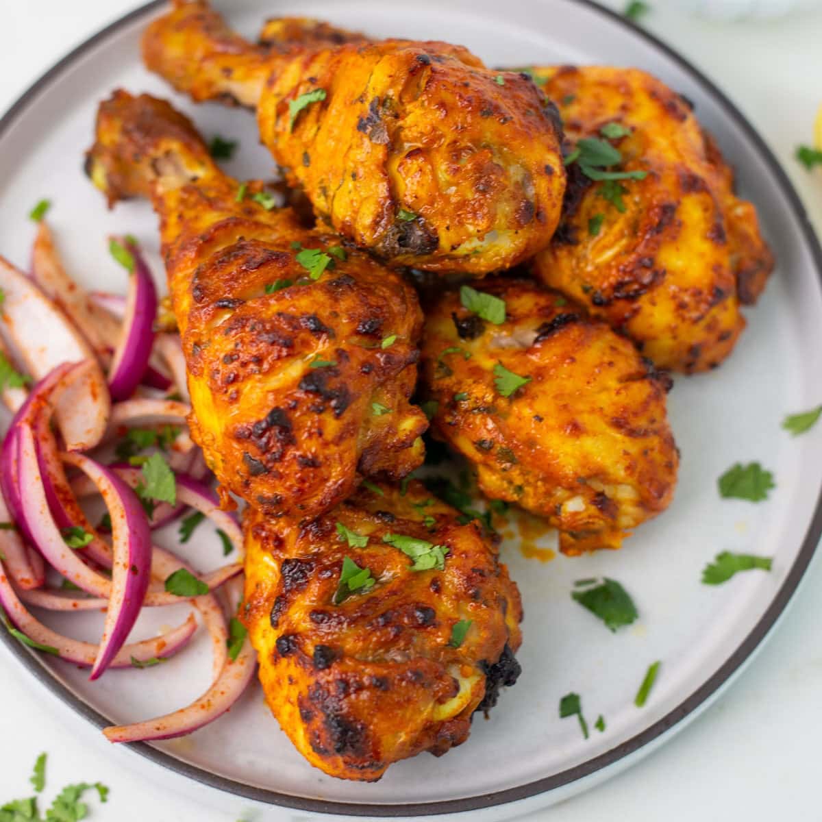Air fryer Tandoori chicken served with pickled onions