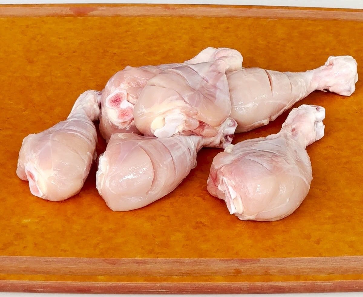 Chicken drumsticks with skin removed and slits added to make tandoori chicken