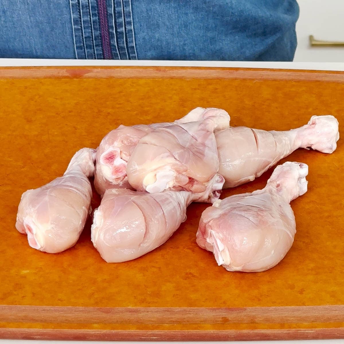 Chicken drumsticks with skin removed and slits added to make tandoori chicken