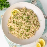 Instant Pot Couscous garnished with chopped parsley and lemon slices