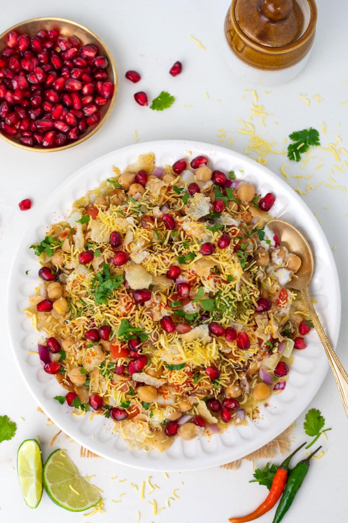 Chole Chaat (chickpea chaat) in a plate garnished with pomegranate seeds.
