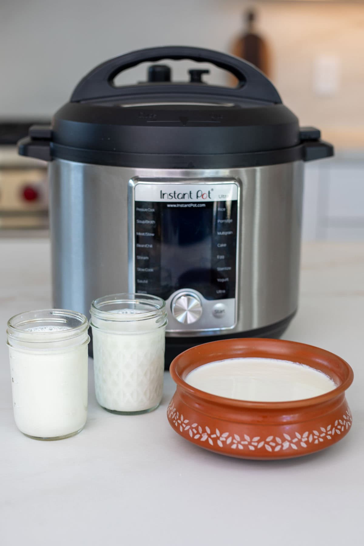 Yogurt set in the instant pot in a bowl and jars