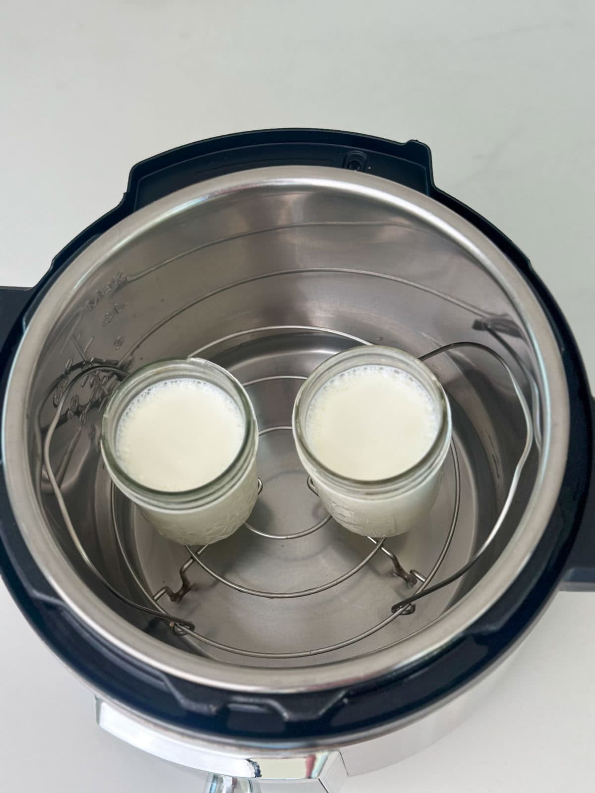 Yogurt being set in jars in the instant pot.