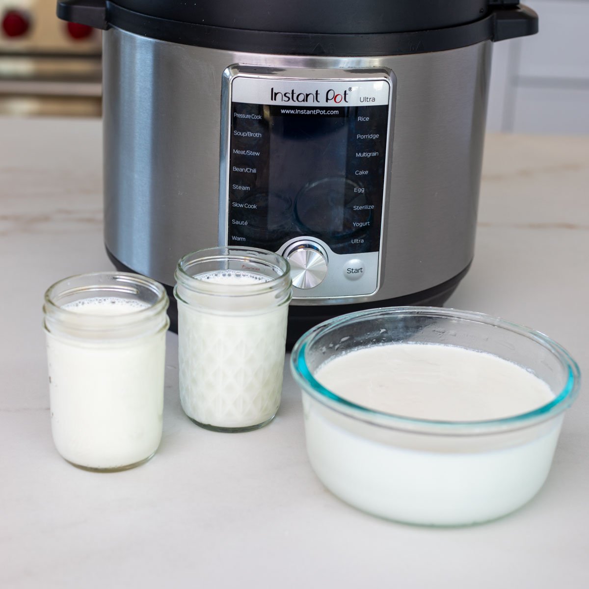 Instant pot yogurt set in a bowl and jars.