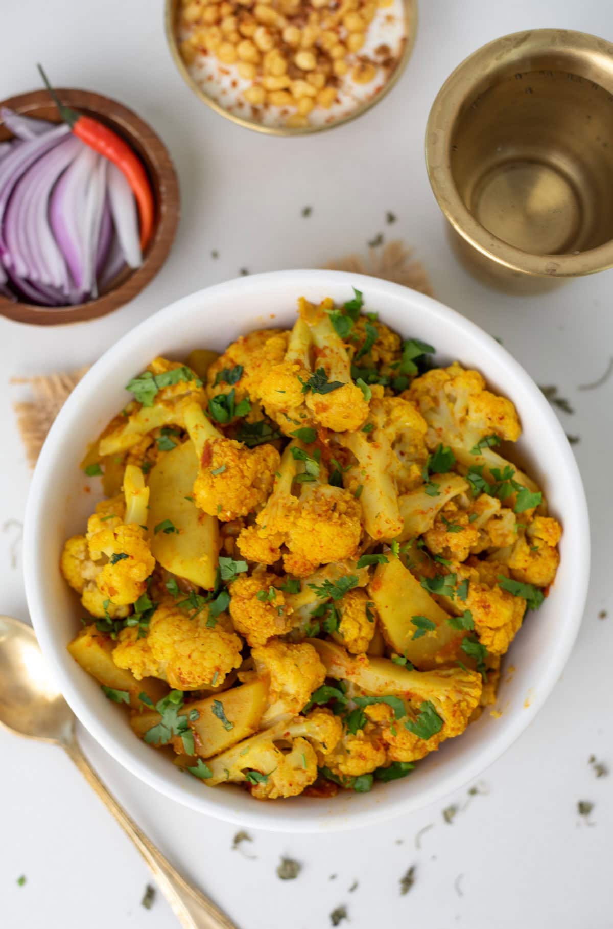 Aloo gobi garnished with cilantro in a white bowl