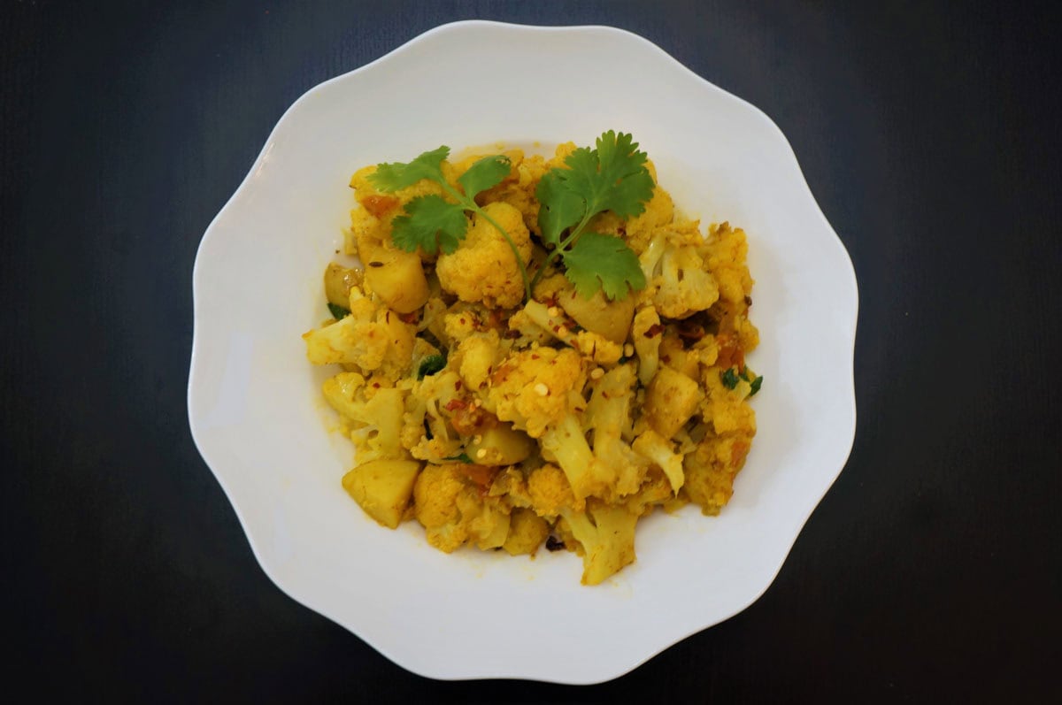 Aloo gobi cooked in the instant pot served on a white plate