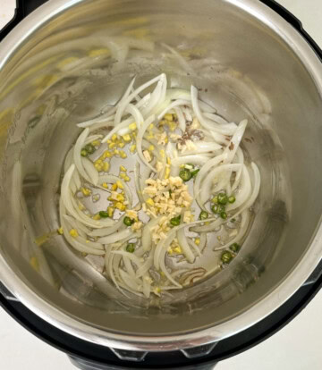 Saute onions, ginger, garlic and green chili in instant pot to make aloo gobi recipe